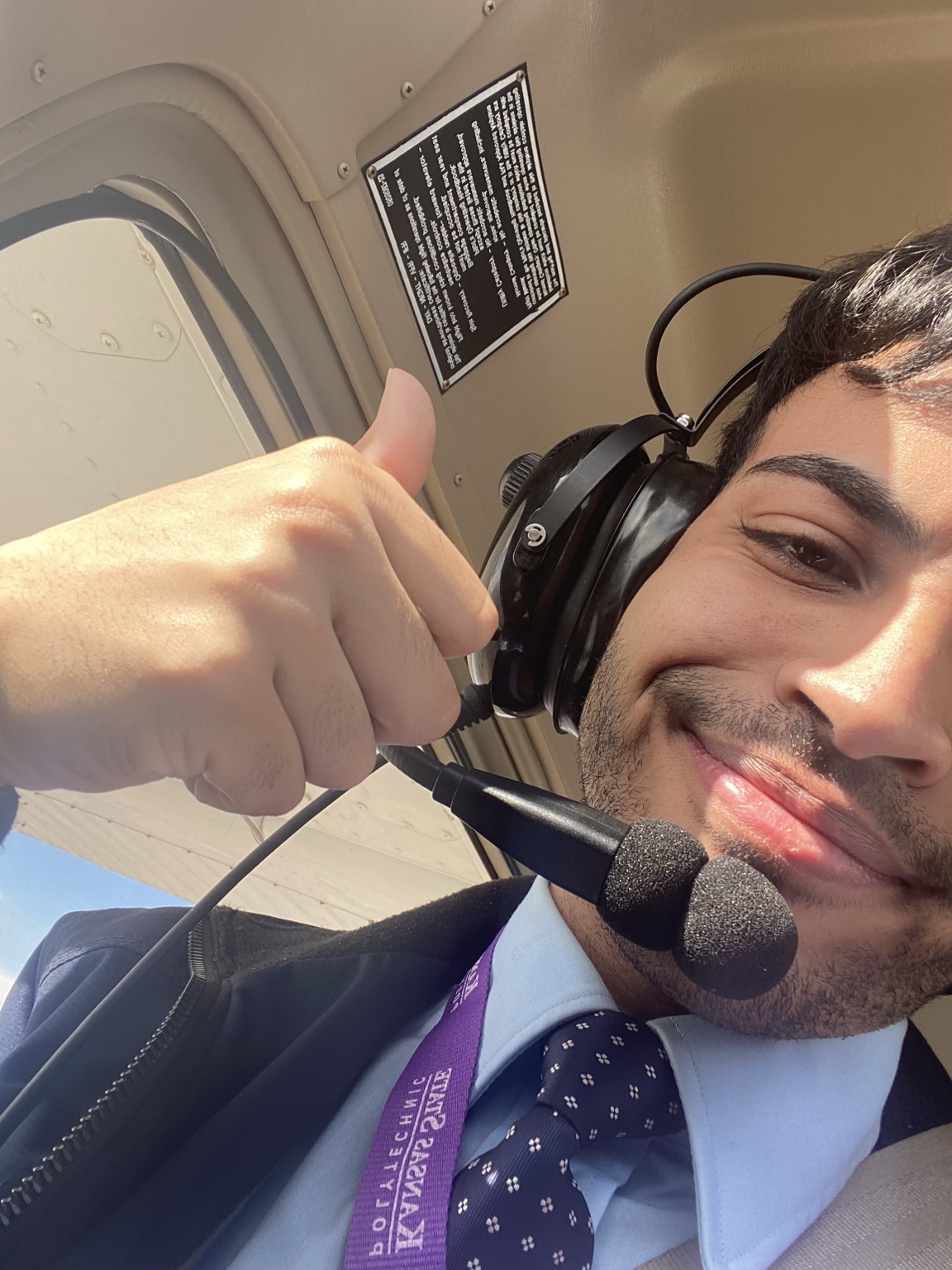 Ibrahim Aldawsari wearing an aviation headset in an aircraft cockpit